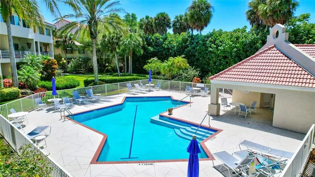 a living room with furniture a flat screen tv and a table