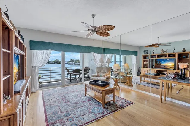 a living room with furniture a rug and a flat screen tv