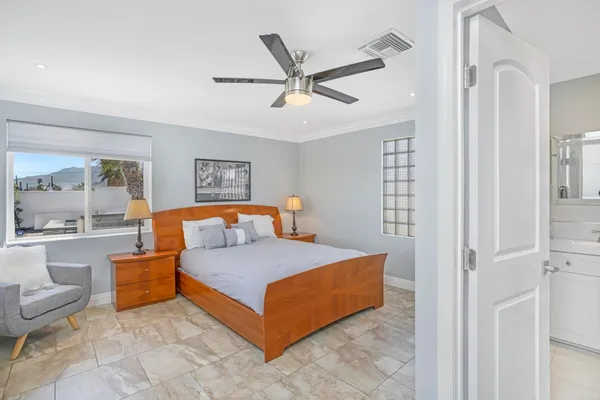 a bedroom with furniture and a large window