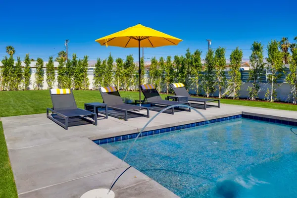a view of a swimming pool and lounge chairs