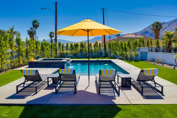 a view of a backyard with sitting area and a slide