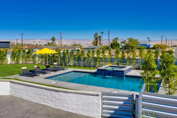 a view of swimming pool with outdoor seating and yard