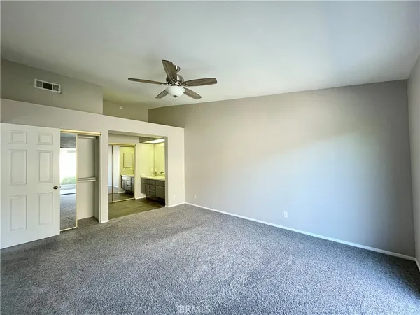an empty room with a empty space and windows