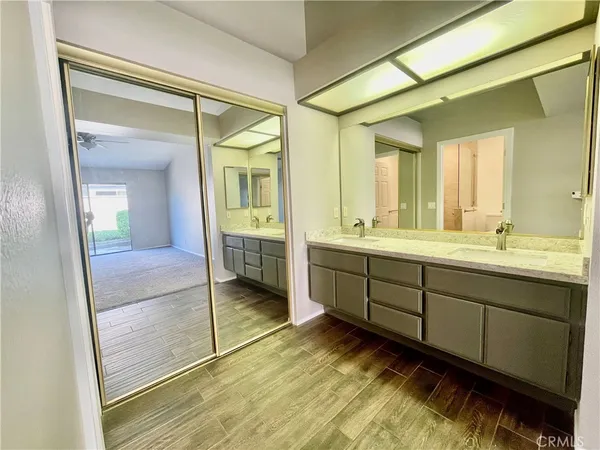 a spacious bathroom with a mirror a shower and vanity