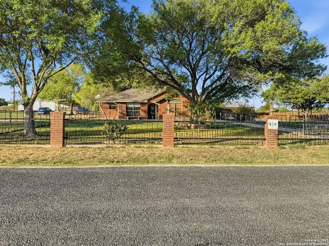 a view of a house with a large trees
