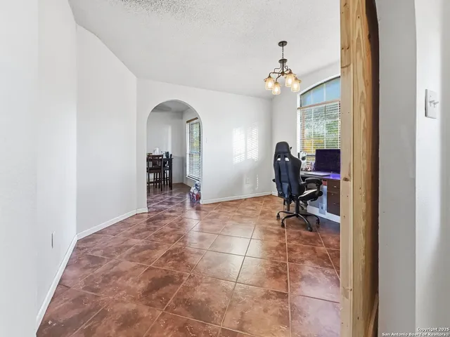 a view of a dining room with furniture and a chandelier