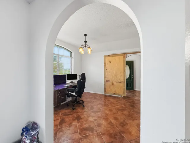 a view of a livingroom with a window and chair