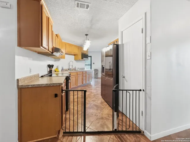a view of a kitchen from the stairs