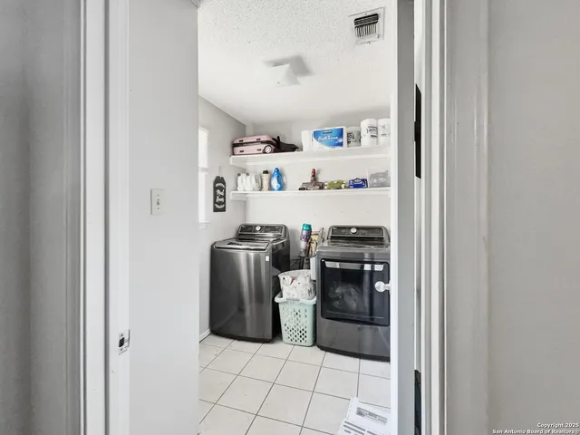 a kitchen with stainless steel appliances granite countertop a refrigerator and a stove