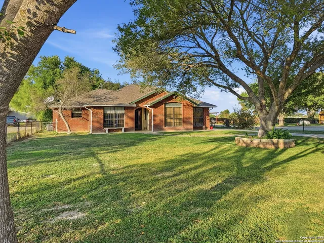 a front view of house with yard and green space