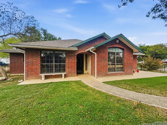 a front view of a house with a garden and yard