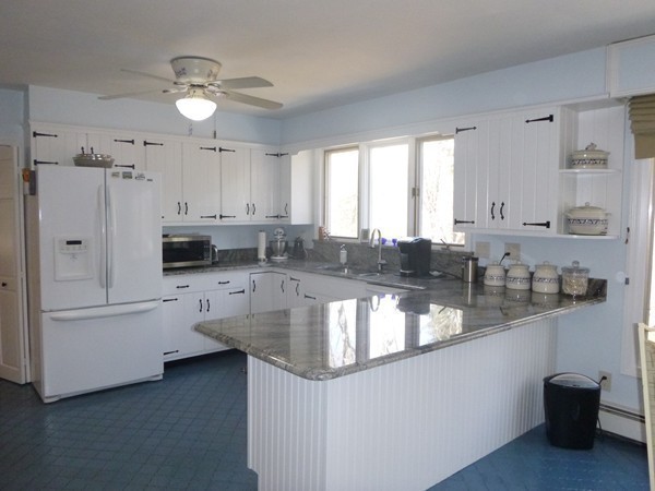 27 Westcott Road Harvard, MA 01451 - Photo 11 of 30 a large kitchen with kitchen island white cabinets and stainless steel appliances