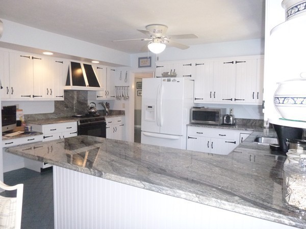 27 Westcott Road Harvard, MA 01451 - Photo 12 of 30 a kitchen with stainless steel appliances kitchen island granite countertop a sink stove and refrigerator