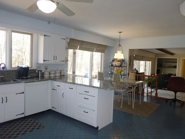 27 Westcott Road Harvard, MA 01451 - Photo 13 of 30 a kitchen that has a lot of white cabinets and wooden floor