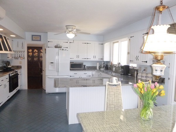 27 Westcott Road Harvard, MA 01451 - Photo 14 of 30 a kitchen with stainless steel appliances kitchen island granite countertop a refrigerator a stove a sink dishwasher and white cabinets with wooden floor