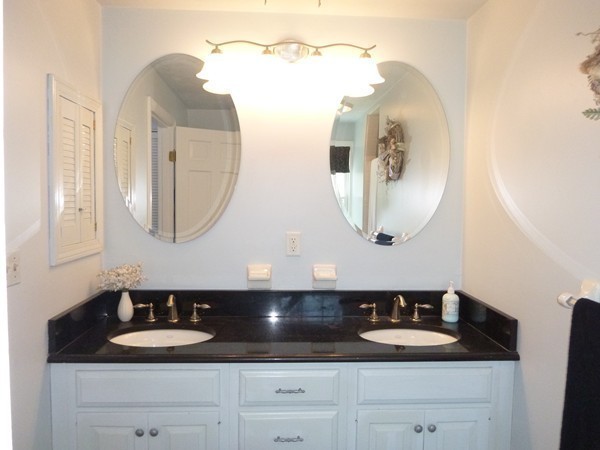 27 Westcott Road Harvard, MA 01451 - Photo 21 of 30 a bathroom with a double vanity sink and a mirror