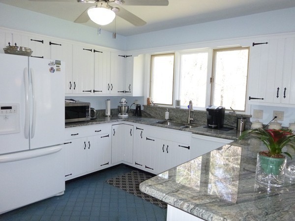 27 Westcott Road Harvard, MA 01451 - Photo 10 of 30 a kitchen with stainless steel appliances kitchen island granite countertop a sink dishwasher and white cabinets with wooden floor