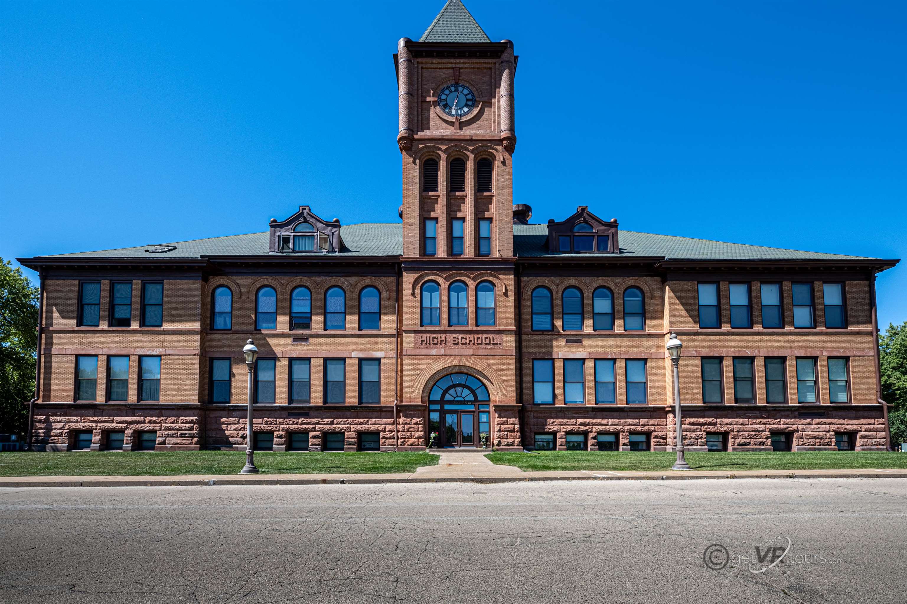 a front view of building with yard and green space