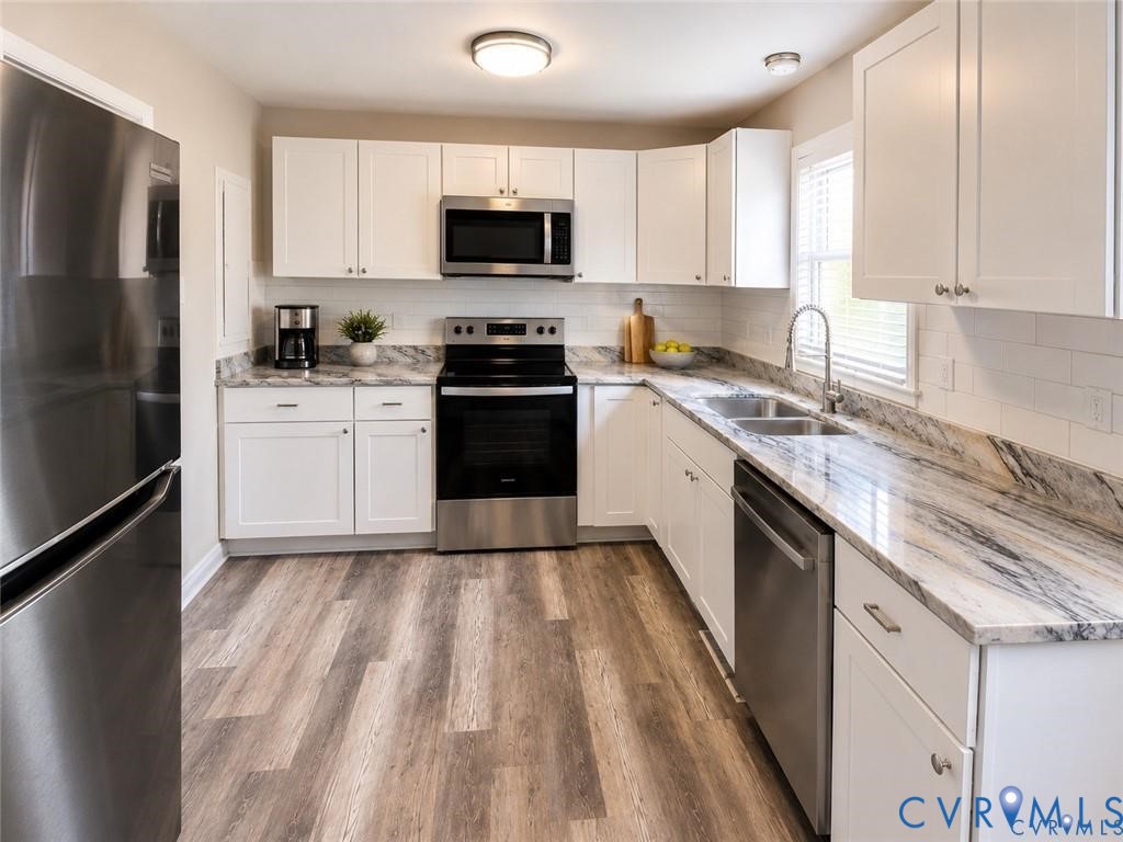 6316 Derwent Road Richmond, VA 23225 - Photo 5 of 10 Modern kitchen featuring wood-finish flooring, whi