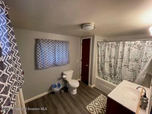 a living room with a couch and a table with wooden floor