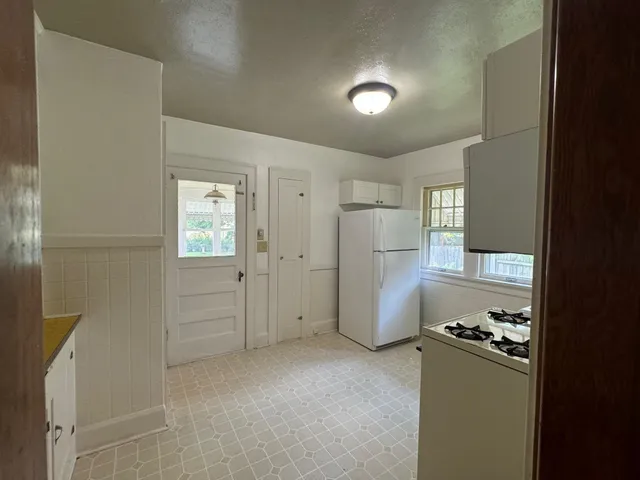 a view of a kitchen with a refrigerator a sink and a dishwasher