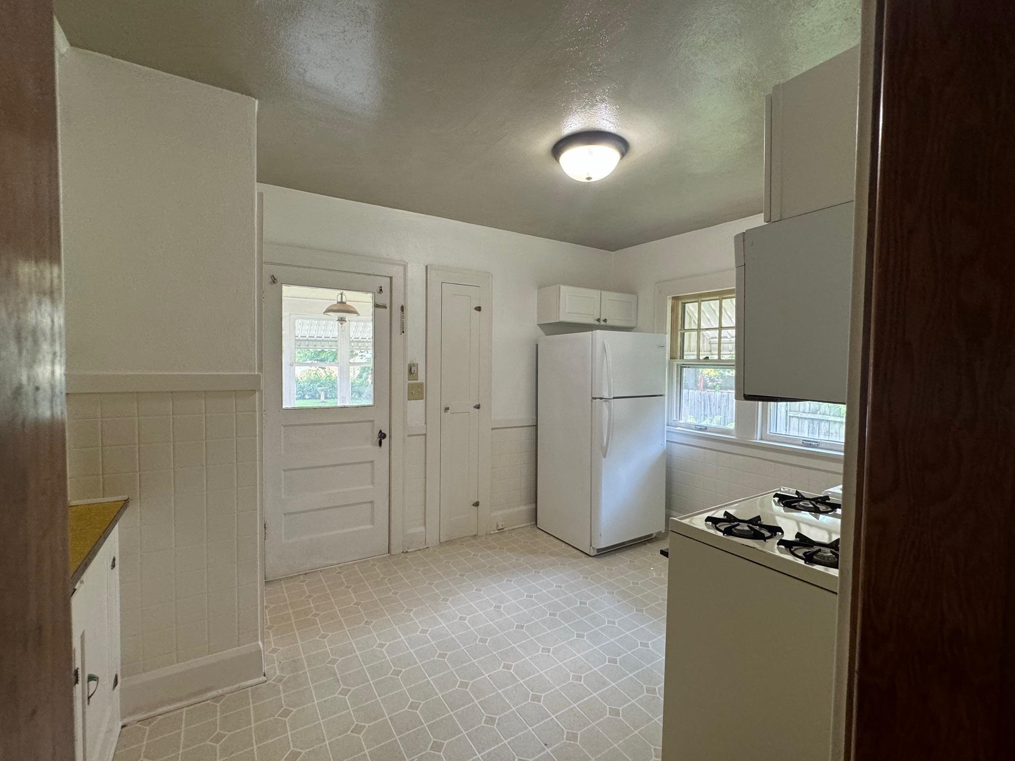 2231 9th Avenue Rockford, IL 61104 - Photo 11 of 44 a view of a kitchen with a refrigerator a sink and a dishwasher