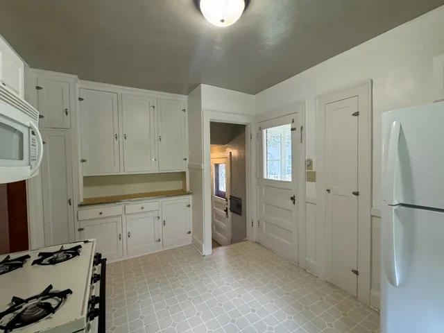 a view of a kitchen with refrigerator and cabinet