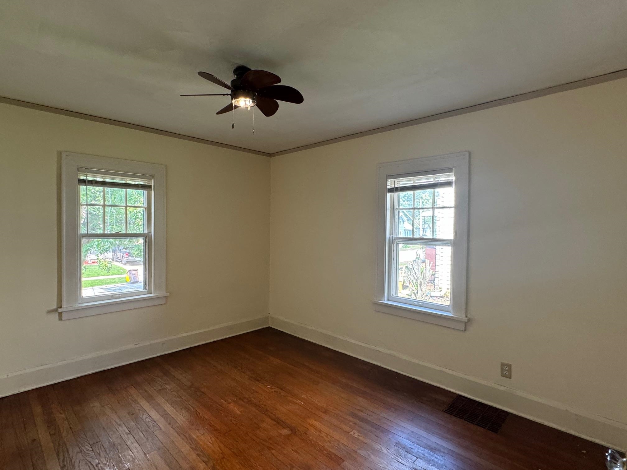 2231 9th Avenue Rockford, IL 61104 - Photo 15 of 44 an empty room with wooden floor ceiling fan and windows
