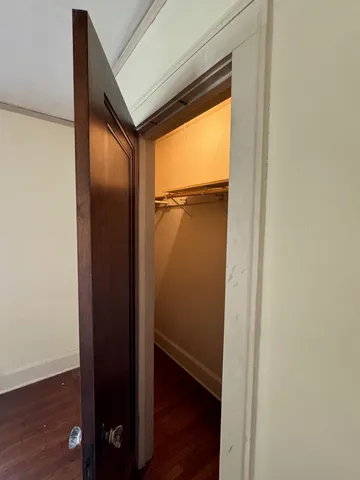a view of walk in closet with wooden floor