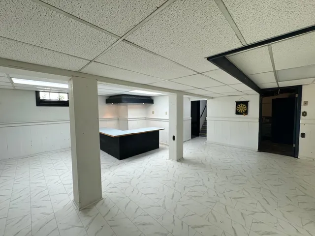 a view of an empty room with closet and cabinet