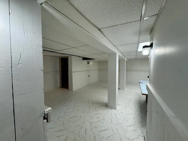 a view of an empty room with a kitchen