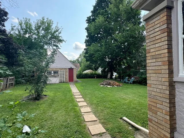 a view of house with backyard space and garden