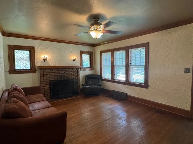 a living room with furniture and a fireplace