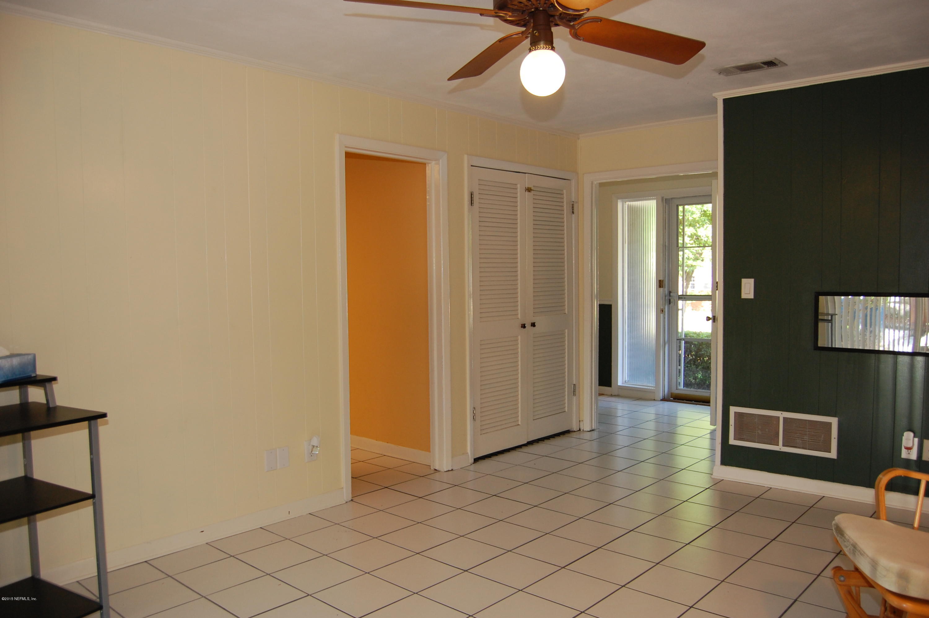 3734 Gurley Road Jacksonville, FL 32277 - Photo 18 of 38 a view of a hallway with wooden floor and chandelier