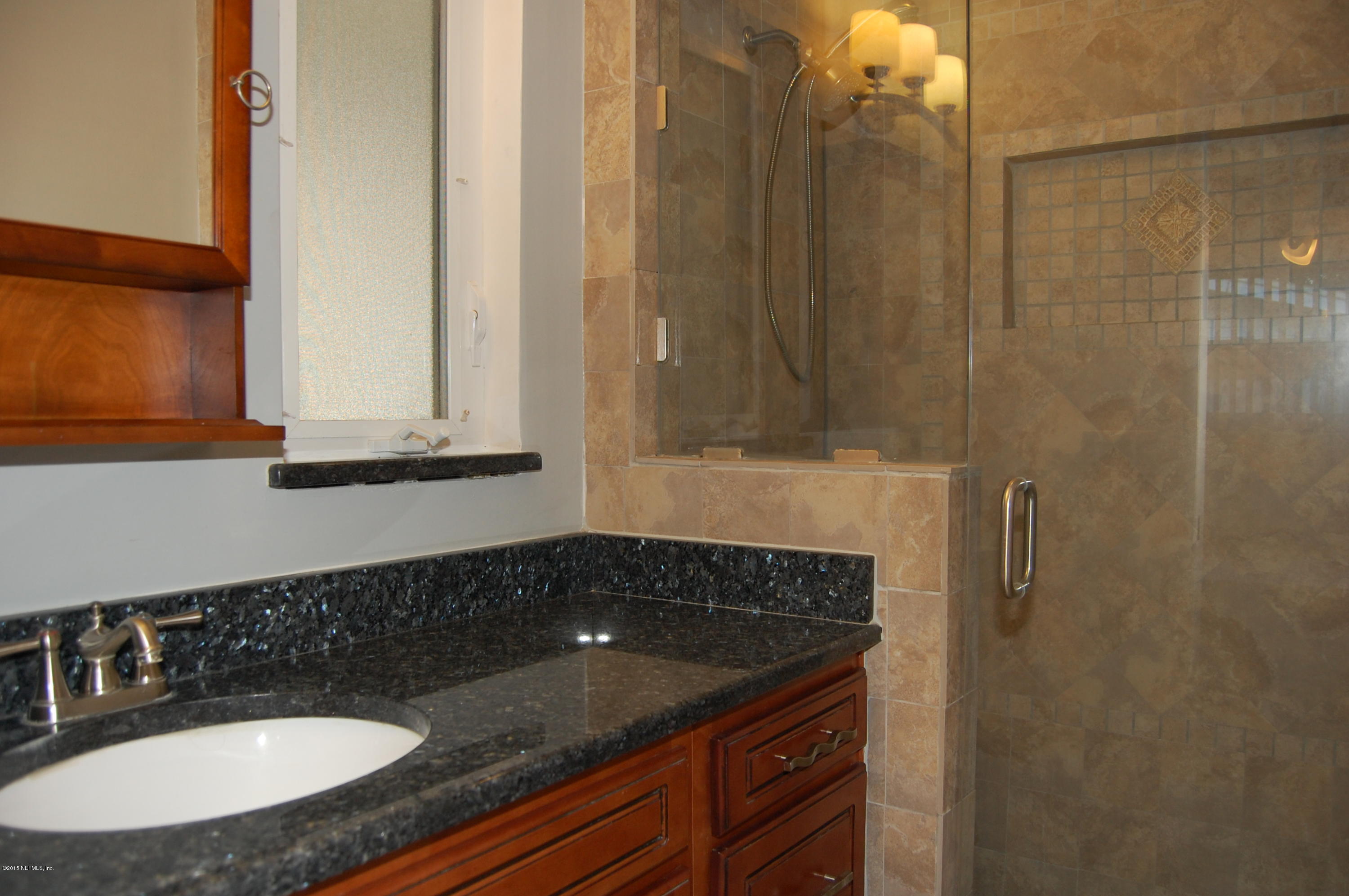 3734 Gurley Road Jacksonville, FL 32277 - Photo 25 of 38 a bathroom with a sink and a mirror