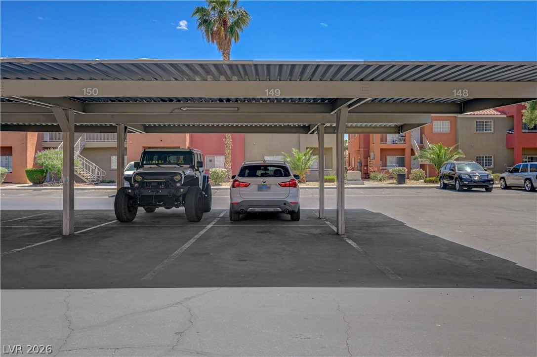 4730 East Craig Road, Unit 1155 Las Vegas, NV 89115 - Photo 26 of 41 Covered parking offers convenience and protection for vehicles, surrounded by vibrant community buildings.