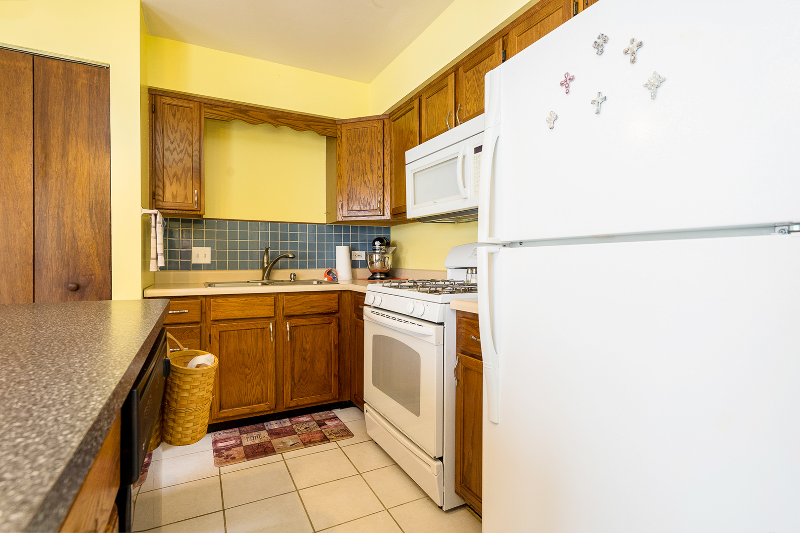204 MacIntyre Street Lockport, IL 60441 - Photo 10 of 27 a kitchen with a refrigerator sink and cabinets