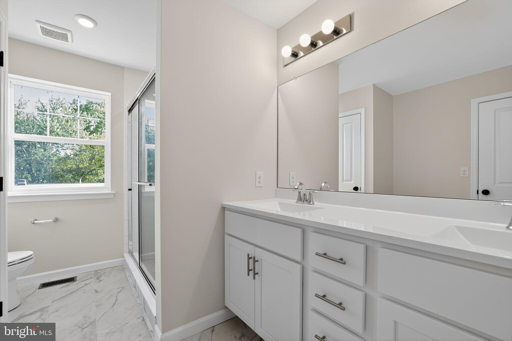 102 High Street Dublin, PA 18917 - Photo 18 of 24 a bathroom with a sink a toilet and a mirror