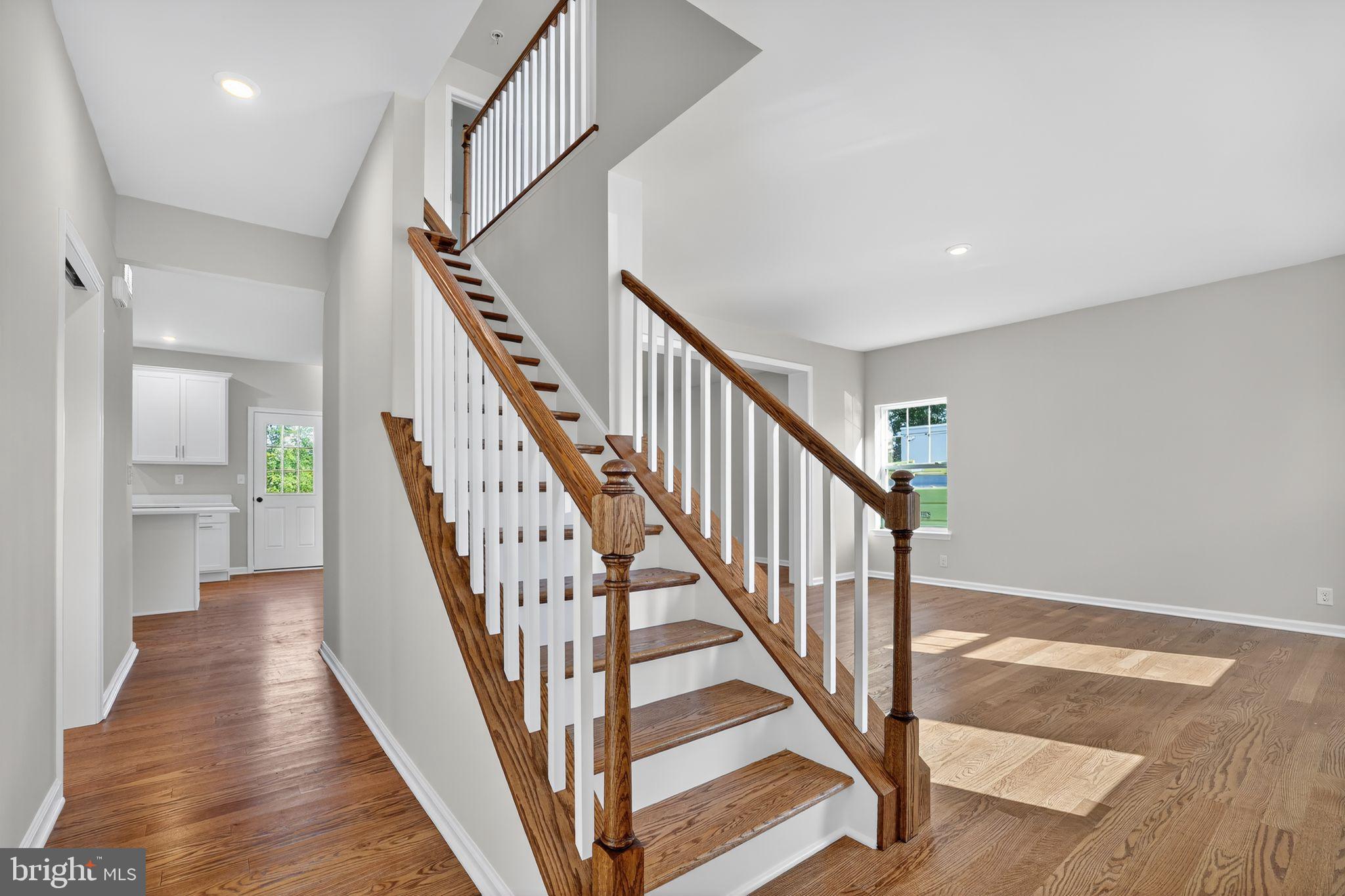 102 High Street Dublin, PA 18917 - Photo 3 of 24 a view of staircase with wooden floor and a chandelier