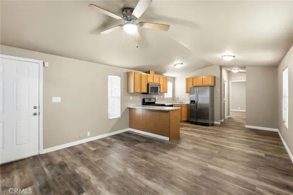 a view of a kitchen with a sink and a refrigerator