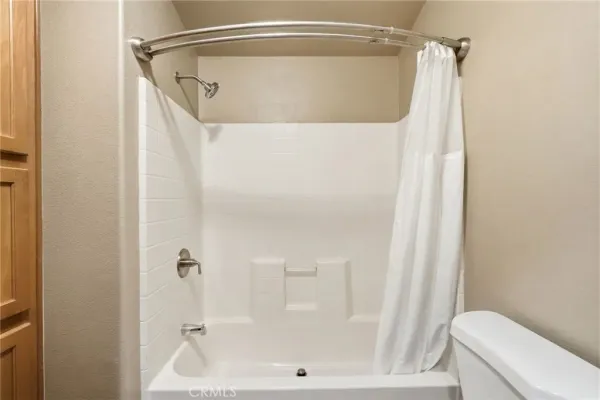a bathroom with a shower and a toilet