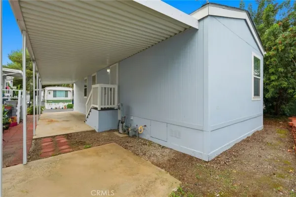 a view of a porch with furniture and floor to ceiling window