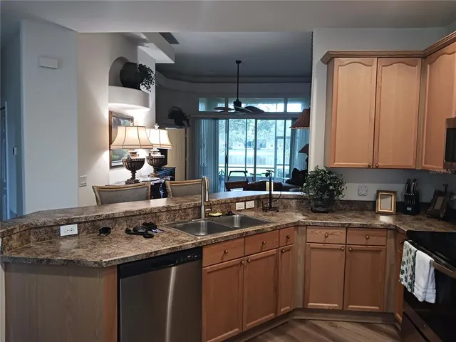 a kitchen with a sink stove and cabinets