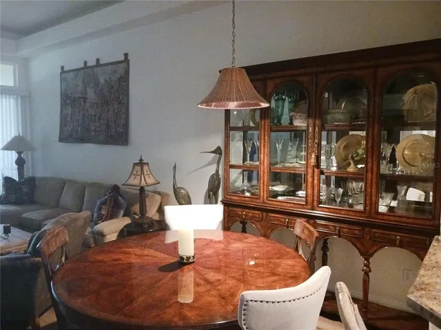 a view of a dining room with a table and chairs