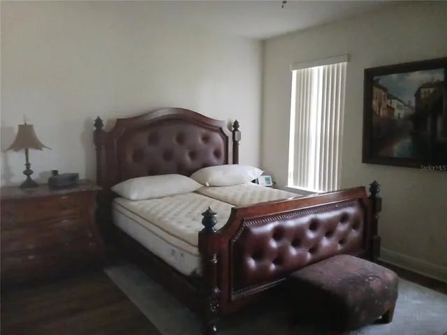 a bedroom with a bed and mirror