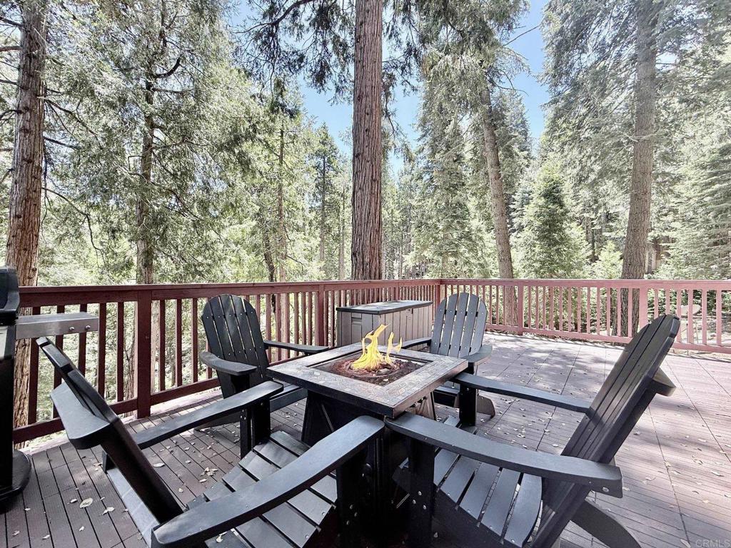 22292 Crestline Road Palomar Mountain, CA 92060 - Photo 1 of 38 a view of a two chairs and table on the deck