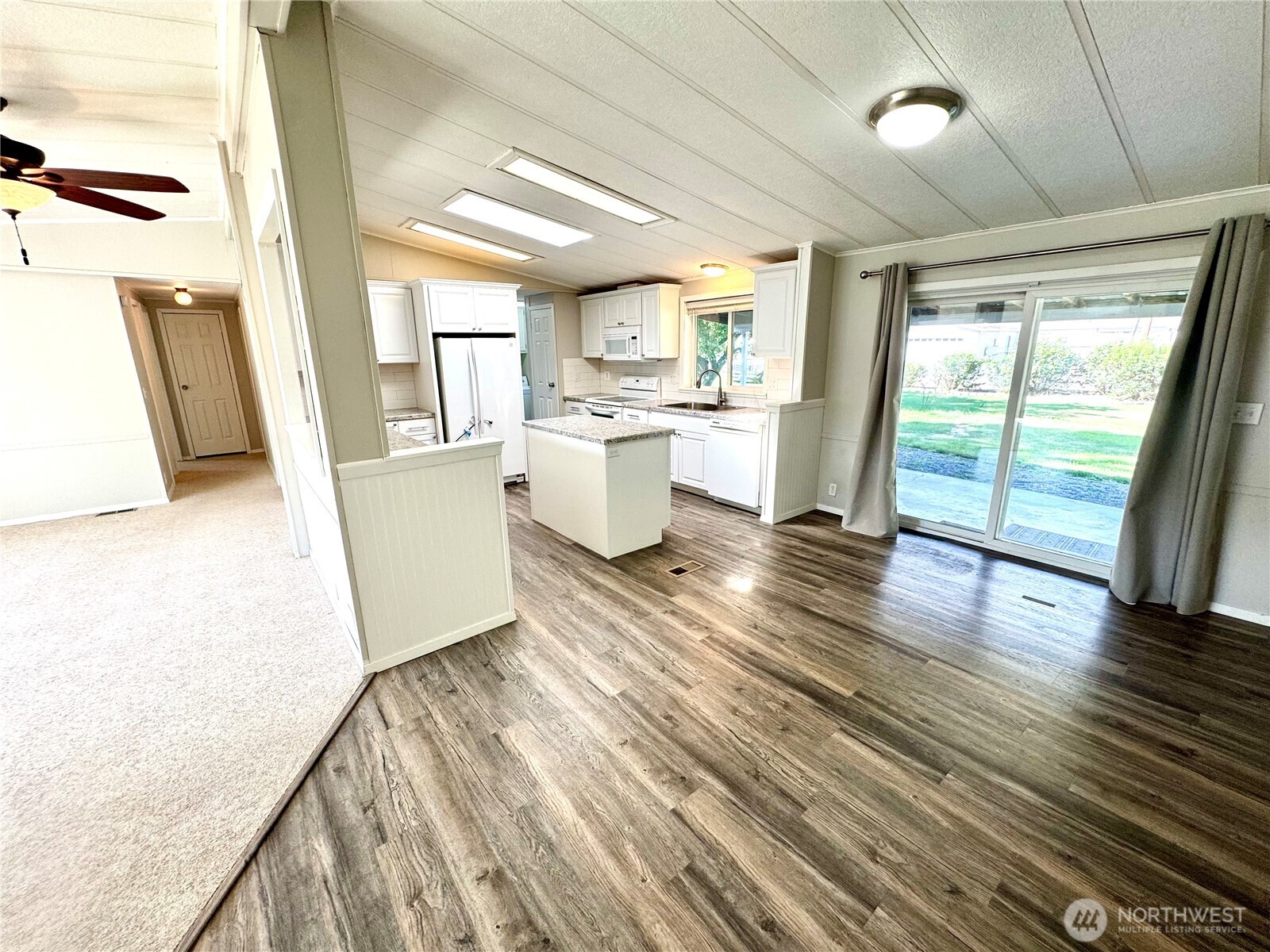 1218 South 3rd Street Dayton, WA 99328 - Photo 8 of 23 a view of a kitchen with wooden floor and electronic appliances