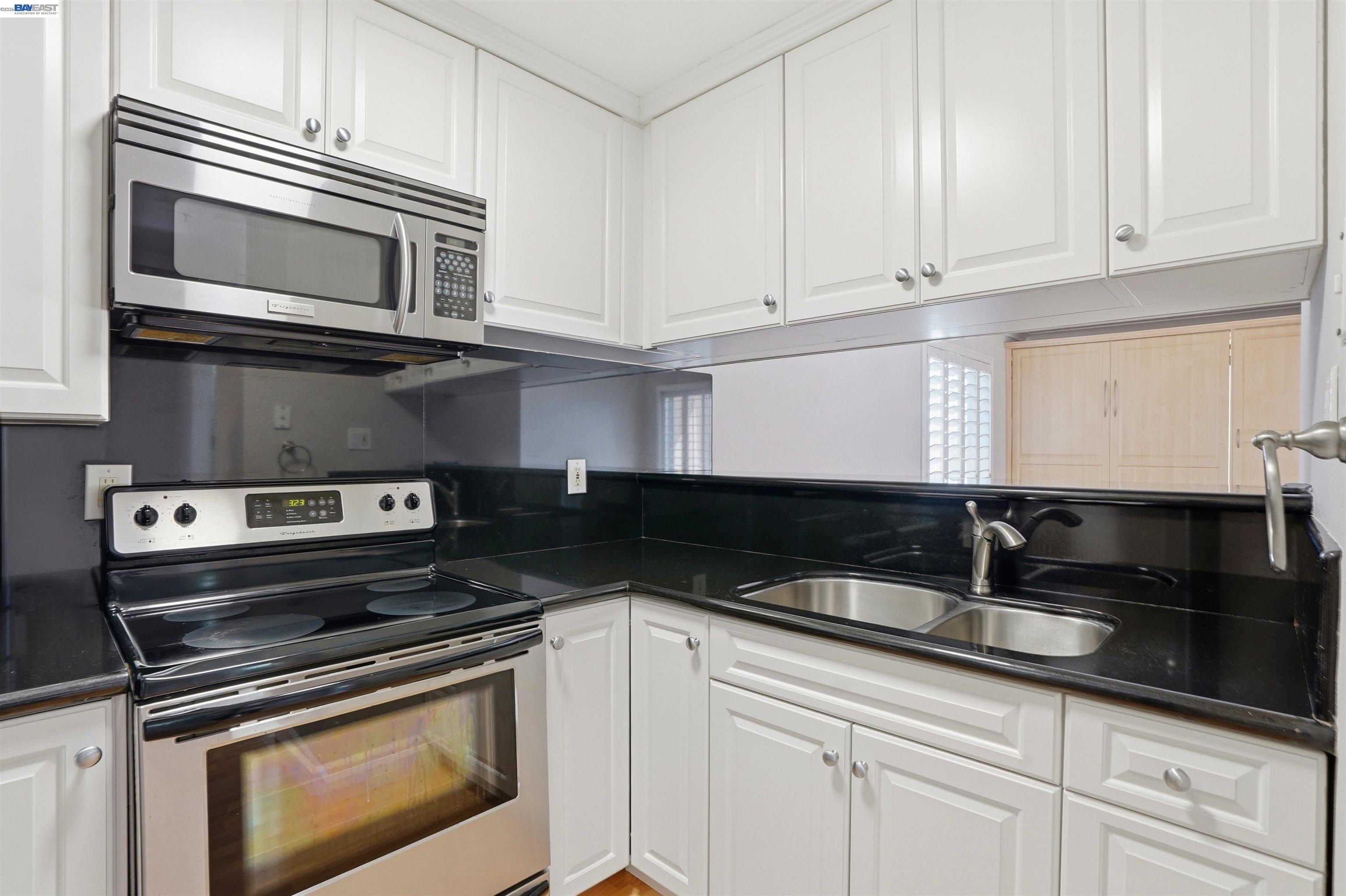735 Watson Canyon Court, Unit 218 San Ramon, CA 94582 - Photo 5 of 18 a kitchen with granite countertop white cabinets and stainless steel appliances
