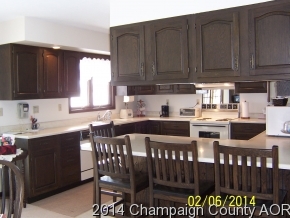 325 Stockholm Road Paxton, IL 60957 - Photo 7 of 16 a kitchen with stainless steel appliances wooden cabinets granite counter tops a stove a sink and a center island