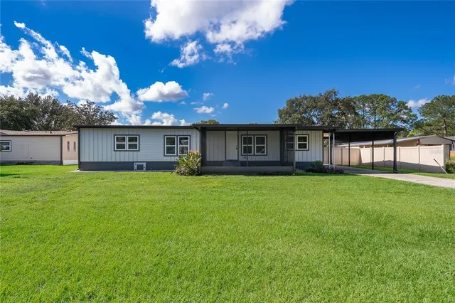 a view of a house with a backyard